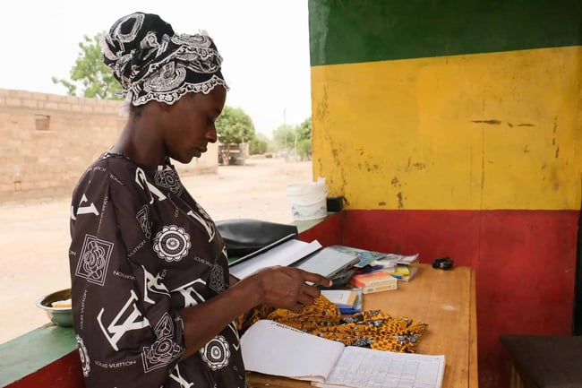 Woman audits farming production log Woman audits farming production log